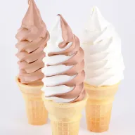 Three soft serve cones in chocolate, swirl, and vanilla flavors