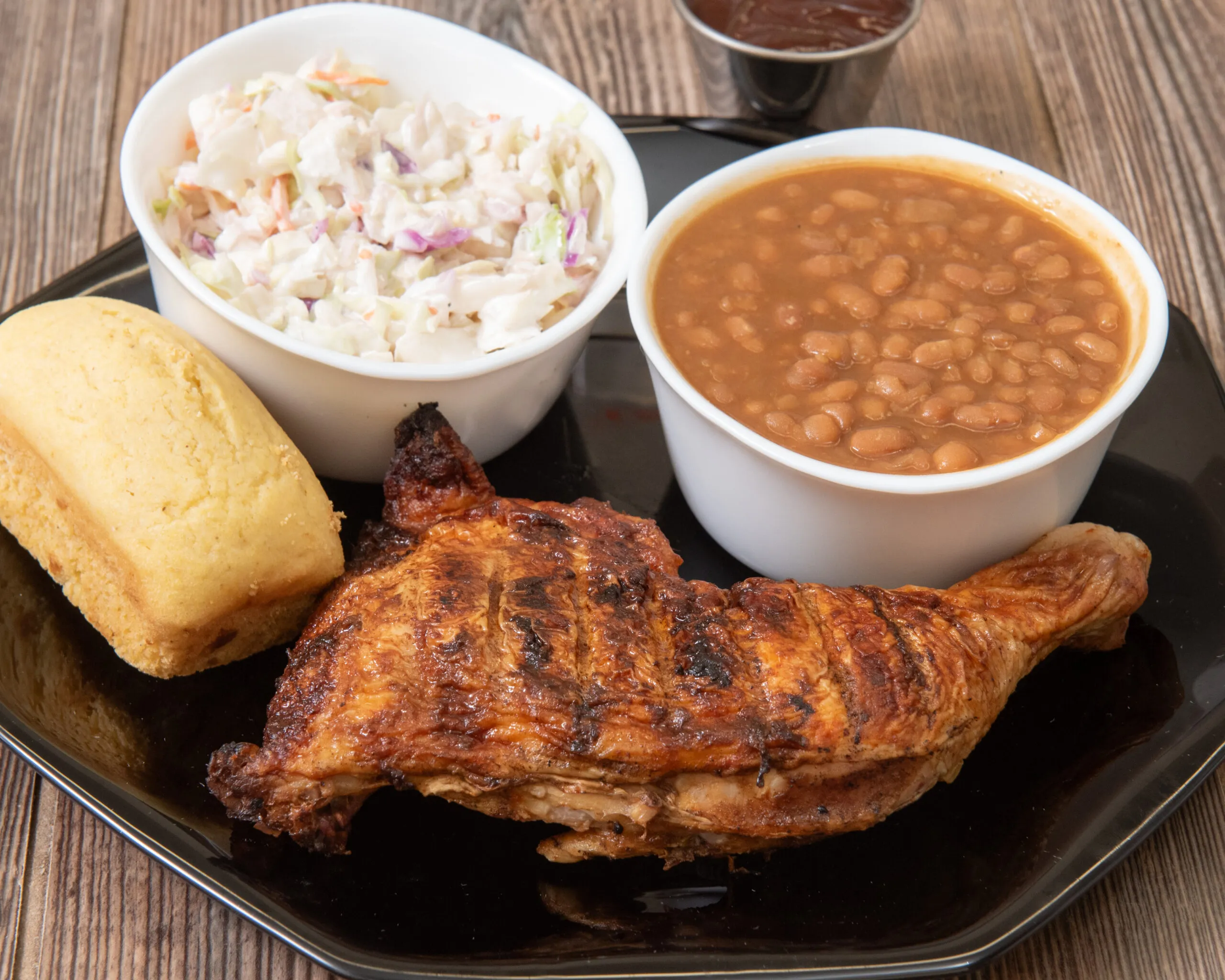 Slow-smoked BBQ chicken quarter with coleslaw, baked beans and cornbread at Bell's Breakaway