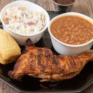 Slow-smoked BBQ chicken quarter with coleslaw, baked beans and cornbread at Bell's Breakaway