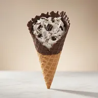 Oreo flurry served in a chocolate dipped homemade waffle cone