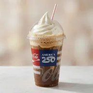 Root beer, Coke, or other soda flavored float topped with vanilla soft serve