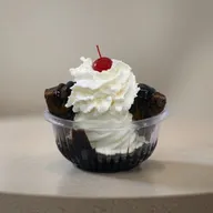 Hot fudge brownie sundae with vanilla soft serve, whipped cream and a cherry